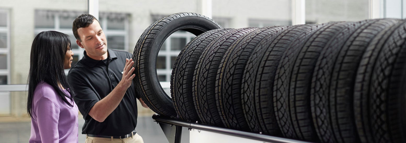 Subaru service representative showing customer a tire. | Santa Monica Subaru in Santa Monica CA